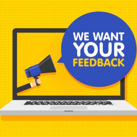 Hand holding megaphone. Laptop notebook computer screen background. We want your feedback in speech bubble. Vector illustration.